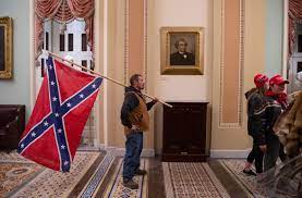 Man photographed with Confederate flag in U.S. Capitol during riot is  arrested | KTLA